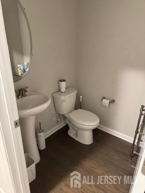 bathroom featuring hardwood / wood-style floors and toilet