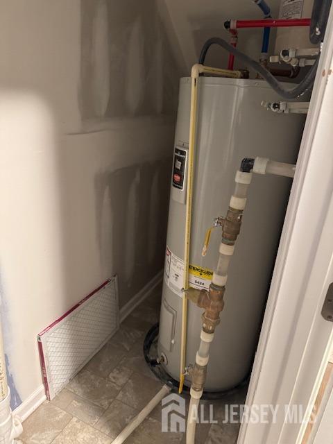 utility room featuring water heater