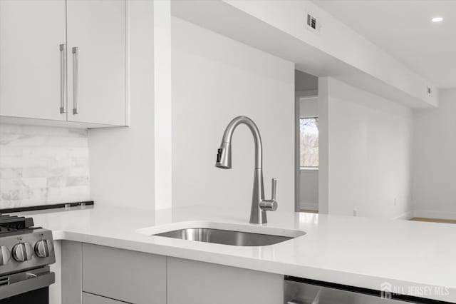 511 Bradley Ct, South Brunswick, NJ 08540 - kitchen with recessed lighting, white cabinets, stainless steel appliances, a sink, and tasteful backsplash