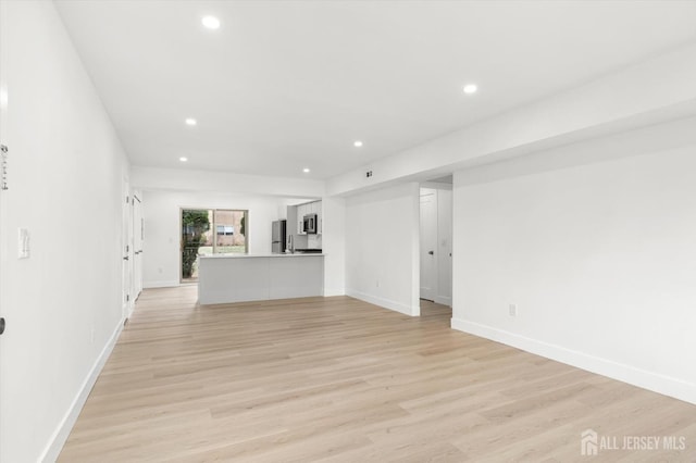 511 Bradley Ct, South Brunswick, NJ 08540 - unfurnished living room featuring light wood-style flooring, baseboards, and recessed lighting