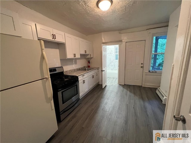 kitchen with a baseboard radiator, dark wood-type flooring, freestanding refrigerator, white cabinetry, and stainless steel gas range