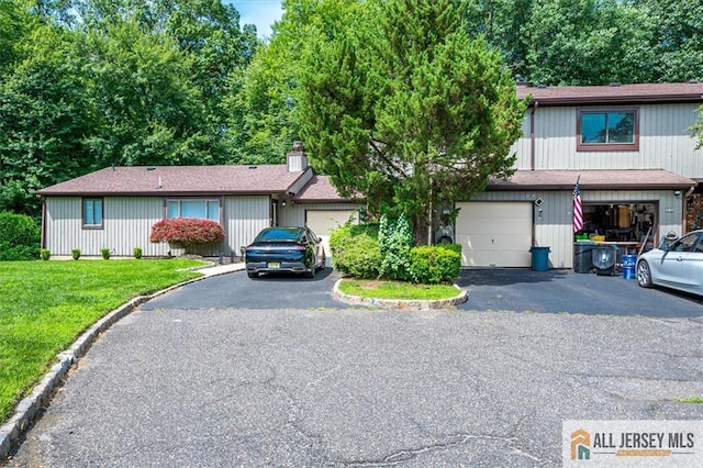 76 Letts Ct Unit 167, Old Bridge, NJ 07747 - view of front of house with asphalt driveway, a front yard, and a chimney