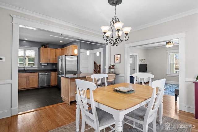 31 Riva Ave, Milltown, NJ 08850 - dining room featuring dark wood-style floors, ornamental molding, a chandelier, stairway, and ceiling fan