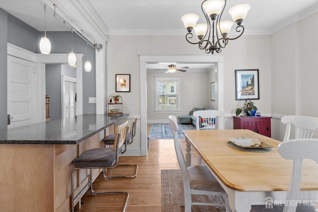 31 Riva Ave, Milltown, NJ 08850 - dining area featuring light wood-type flooring, ornamental molding, a ceiling fan, a chandelier, and baseboards