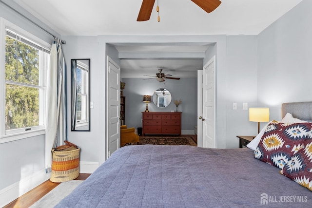31 Riva Ave, Milltown, NJ 08850 - bedroom featuring multiple windows, baseboards, and wood finished floors
