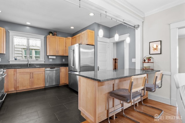 31 Riva Ave, Milltown, NJ 08850 - kitchen featuring appliances with stainless steel finishes, a sink, a breakfast bar area, dark stone counters, and a peninsula