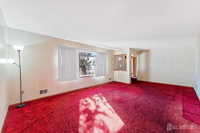 unfurnished room featuring visible vents and carpet flooring