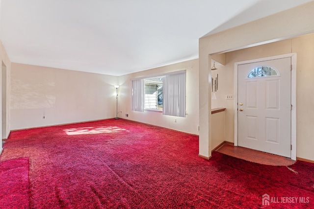 foyer entrance with carpet floors