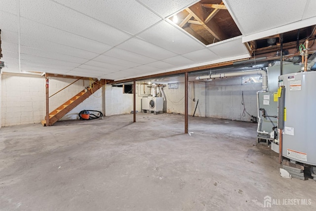 basement featuring water heater and washer and dryer