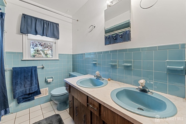 bathroom with toilet, a sink, visible vents, and tile patterned floors