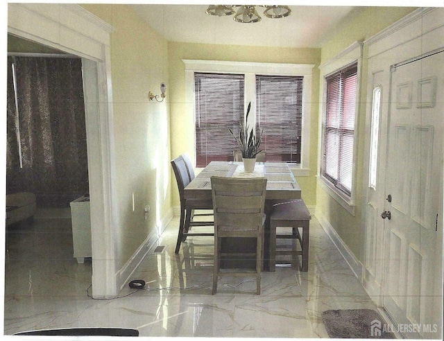 dining room featuring visible vents, baseboards, and marble finish floor