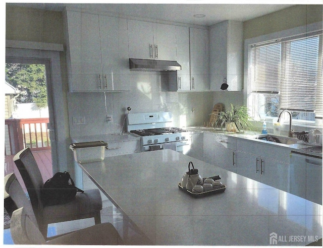 307 Poll Pl, Edison, NJ 08817 - kitchen featuring white gas range oven, under cabinet range hood, light countertops, decorative backsplash, and dishwasher