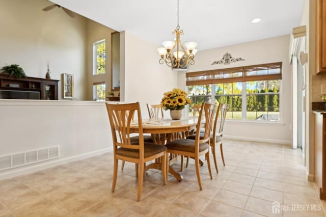 dining space featuring light tile patterned flooring and a chandelier