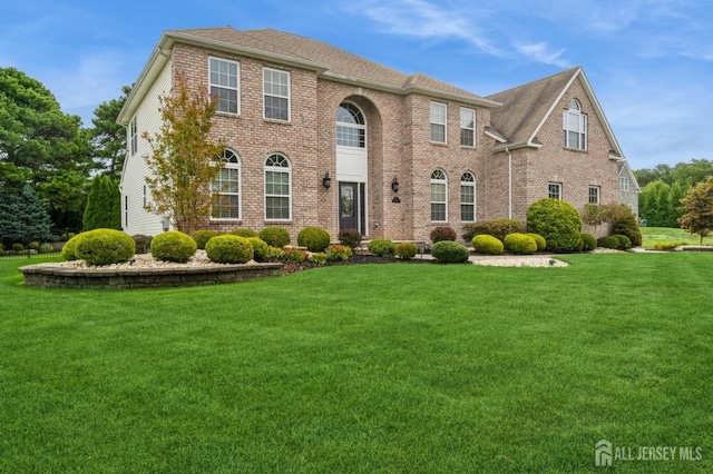 colonial-style house with a front yard