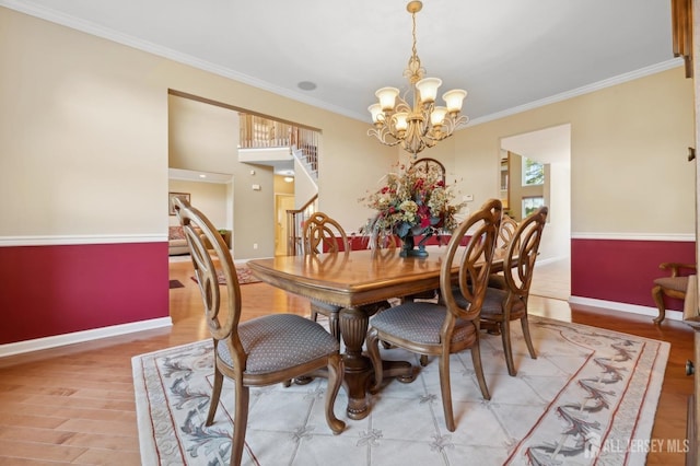 dining room featuring hardwood / wood-style floors, ornamental molding, and a chandelier