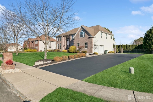 view of front of house with a front lawn and a garage