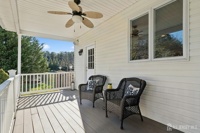 wooden terrace featuring ceiling fan