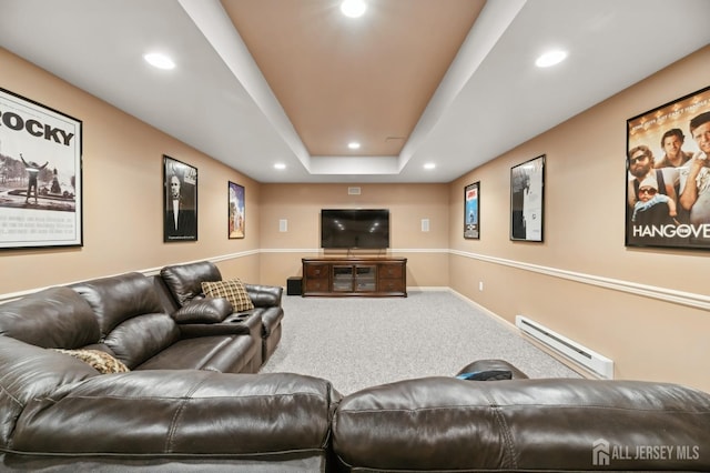 carpeted living room featuring a raised ceiling and a baseboard radiator