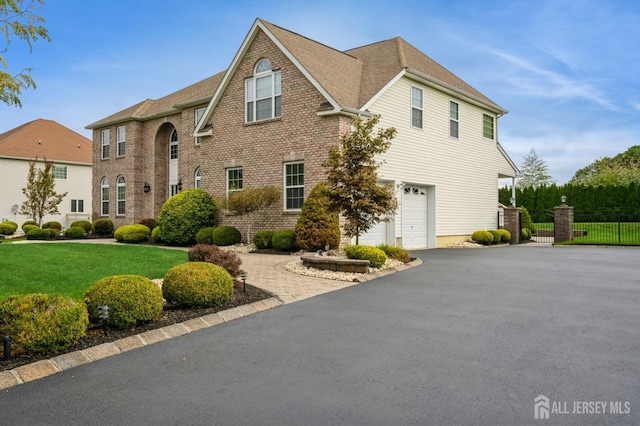 front facade with a front lawn and a garage