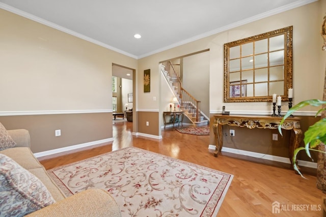 sitting room featuring crown molding and hardwood / wood-style flooring