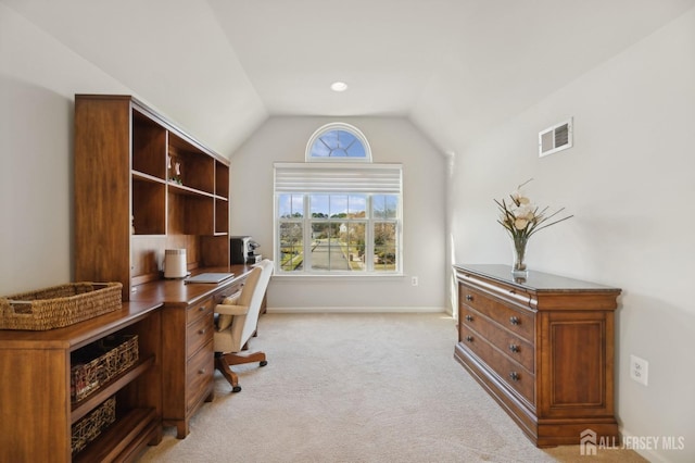 office space featuring lofted ceiling and light carpet