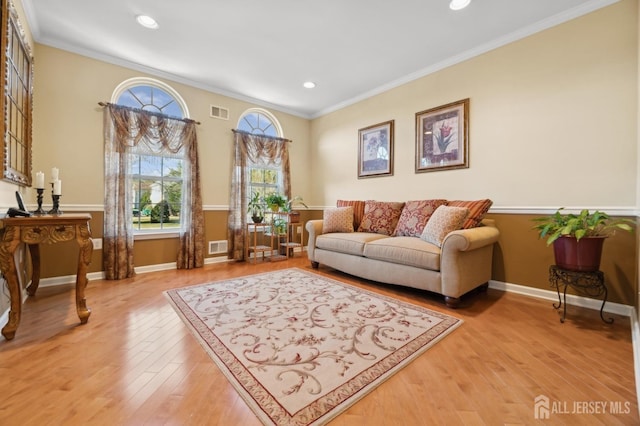 living room with ornamental molding and hardwood / wood-style flooring