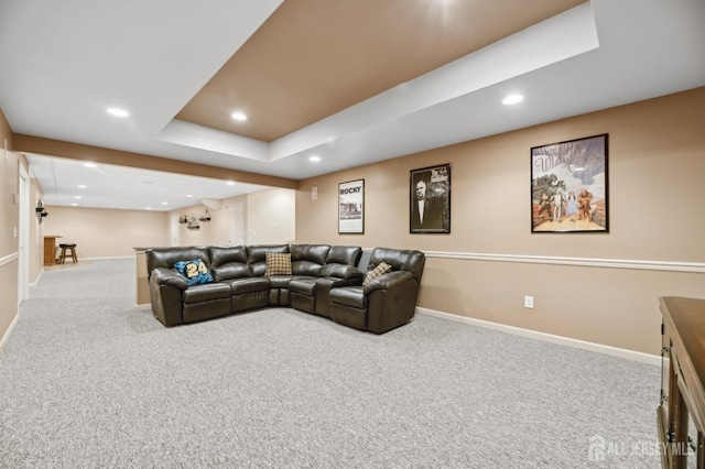 living room featuring a raised ceiling and light carpet