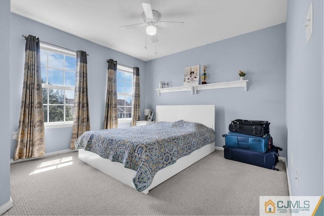 bedroom featuring multiple windows, carpet floors, and ceiling fan