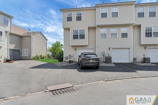 multi unit property featuring cooling unit and a garage