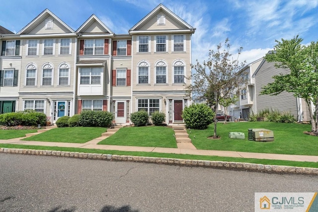 view of property featuring a front lawn