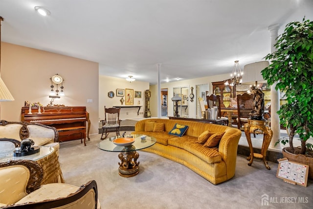 carpeted living room with a chandelier and decorative columns