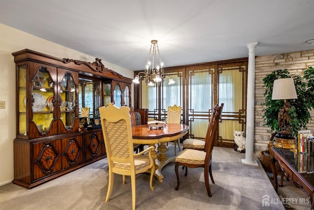 carpeted dining space featuring ornate columns, radiator heating unit, and a notable chandelier