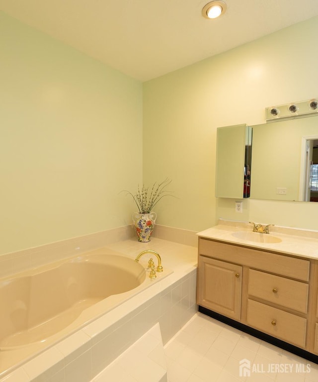 bathroom featuring a garden tub and vanity