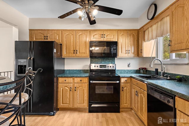 kitchen with ceiling fan, a sink, black appliances, and dark countertops