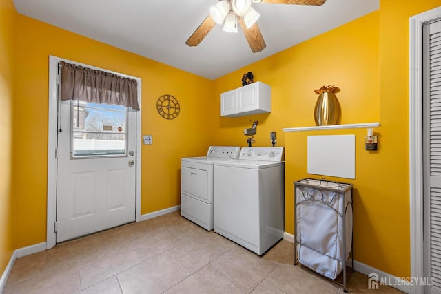 laundry area featuring baseboards, light tile patterned floors, washer and clothes dryer, cabinet space, and ceiling fan