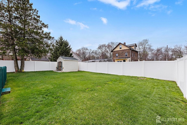view of yard with a shed, a fenced backyard, and an outdoor structure