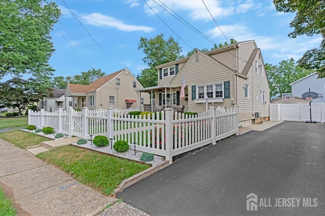 229 Harris Ave, Middlesex, NJ 08846 - view of front of home with covered porch, a detached garage, a gate, and a fenced front yard