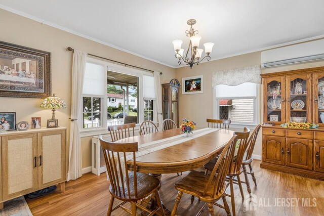 229 Harris Ave, Middlesex, NJ 08846 - dining space with a wall unit AC, a chandelier, light wood-style floors, and ornamental molding