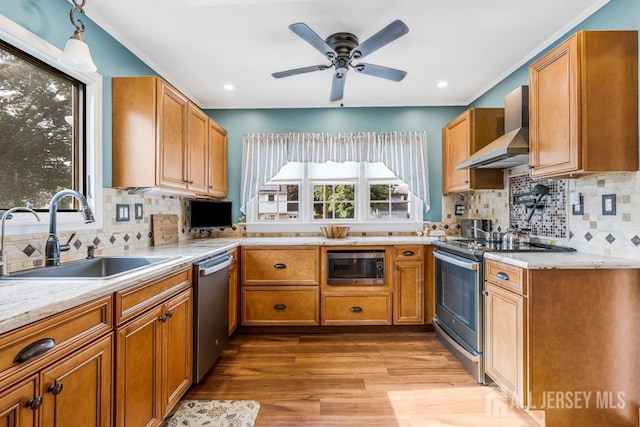 229 Harris Ave, Middlesex, NJ 08846 - kitchen featuring appliances with stainless steel finishes, wall chimney range hood, backsplash, ceiling fan, and brown cabinets