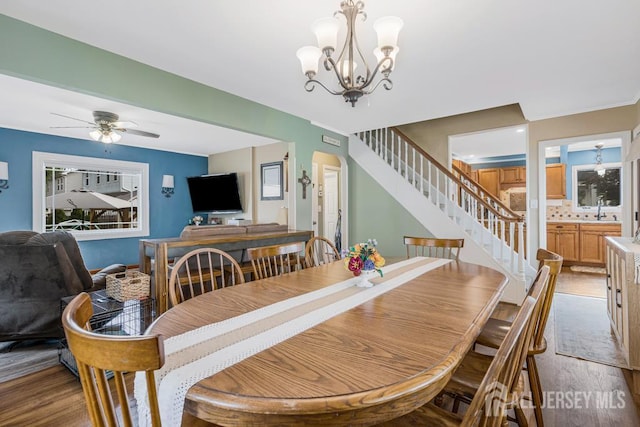 229 Harris Ave, Middlesex, NJ 08846 - dining room featuring wood finished floors, stairs, a chandelier, and ceiling fan