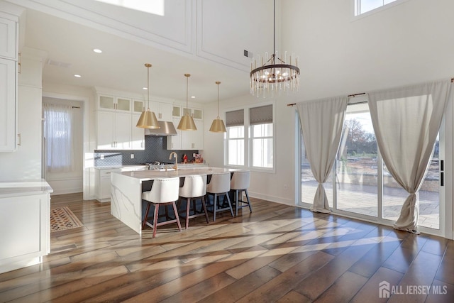 21 Cole Pl, Cranbury, NJ 08512 - kitchen featuring light wood-style floors, a center island with sink, white cabinetry, light countertops, and recessed lighting