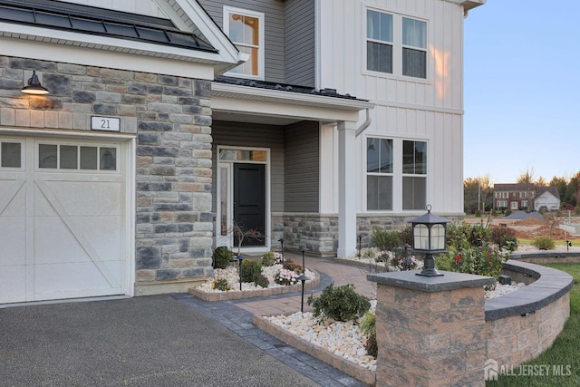 21 Cole Pl, Cranbury, NJ 08512 - property entrance with stone siding, a garage, and board and batten siding
