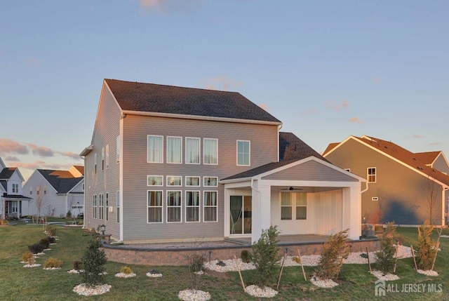 21 Cole Pl, Cranbury, NJ 08512 - back of property at dusk with ceiling fan, a patio area, and a lawn