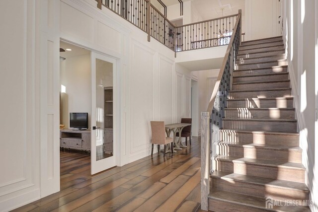 21 Cole Pl, Cranbury, NJ 08512 - staircase with a decorative wall, a high ceiling, and wood finished floors