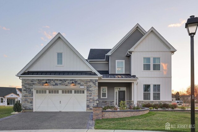 21 Cole Pl, Cranbury, NJ 08512 - craftsman-style home with a standing seam roof, stone siding, asphalt driveway, an attached garage, and a front lawn