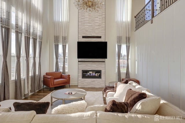 21 Cole Pl, Cranbury, NJ 08512 - living room featuring a tile fireplace, a high ceiling, wood finished floors, and healthy amount of natural light