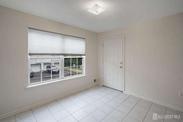 116 Prestwick Way, Edison, NJ 08820 - empty room with a textured ceiling and light tile patterned floors