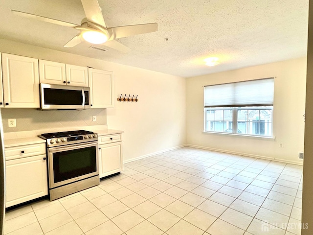 116 Prestwick Way, Edison, NJ 08820 - kitchen with stainless steel appliances, light countertops, white cabinets, decorative backsplash, and a textured ceiling