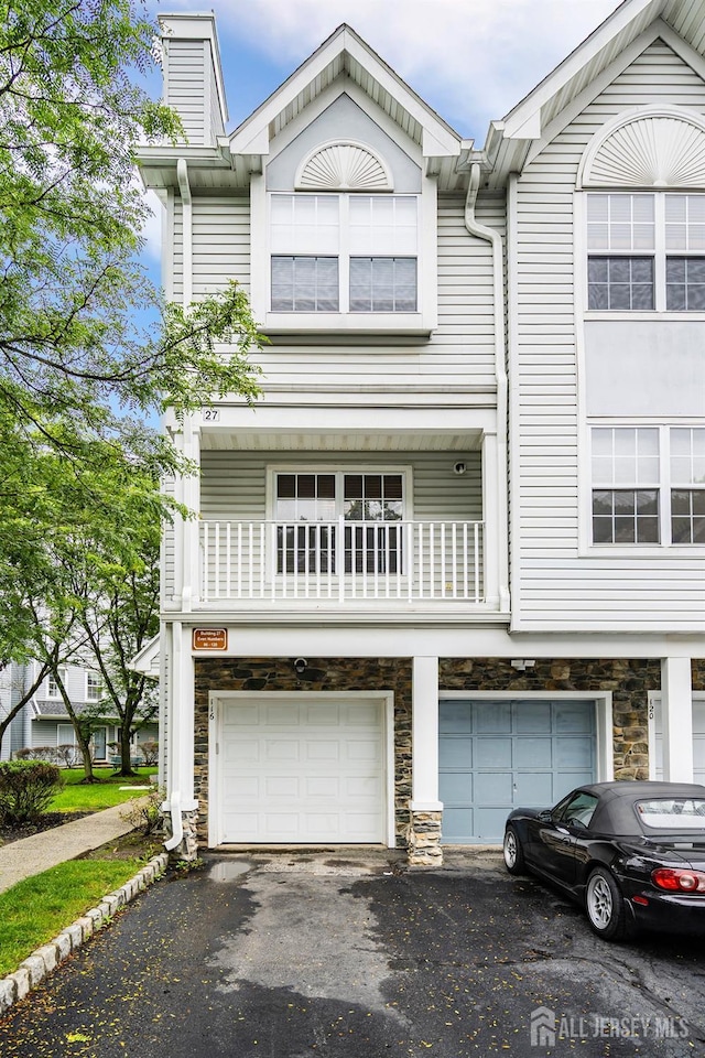 116 Prestwick Way, Edison, NJ 08820 - view of front facade featuring an attached garage, stone siding, driveway, and a chimney