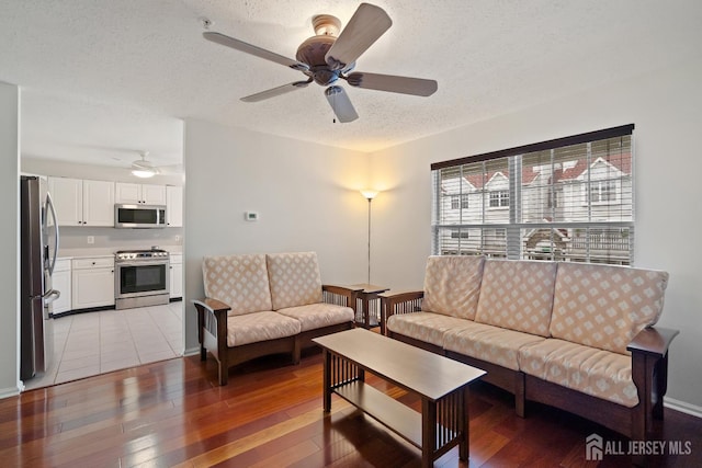 116 Prestwick Way, Edison, NJ 08820 - living room featuring a ceiling fan, light wood-style floors, and a textured ceiling